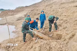 Quả bom được phát hiện bên phải bờ sông Lam (cách cầu Đô Lương hơn 200m) thuộc địa phận xóm Đặng Sơn, xã Đô Lương. (Ảnh: TTXVN phát)