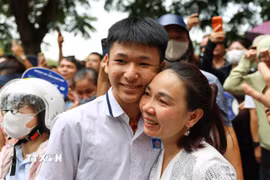 Phụ huynh vui mừng đón thí sinh sau khi hoàn thành môn thi đầu tiên tại điểm thi Trường Trung học phổ thông Trần Nhân Tông. (Ảnh: Thanh Tùng/ TTXVN)