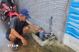 Ông Huỳnh Tài, 71 tuổi, bức xúc cho rằng nước thường trào ngược tại hố ga mỗi khi giờ cao điểm. (Ảnh: Sỹ Thắng/ TTXVN)