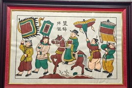 Tranh Đông Hồ "Vinh quy bái tổ". (Ảnh: Thanh Thương/TTXVN)