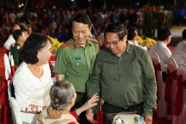 Thủ tướng Phạm Minh Chính cùng Bộ trưởng Bộ Công an Lương Tam Quang thăm hỏi các cán bộ lão thành cách mạng. (Ảnh: Giang Phương/TTXVN)