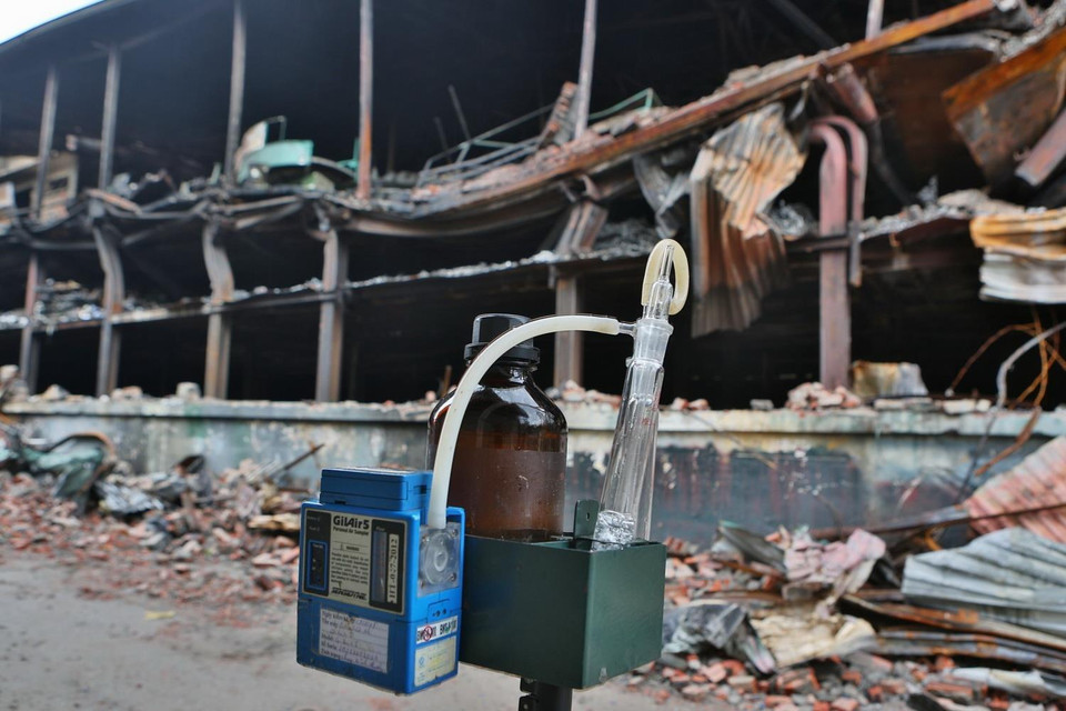 Đoàn cán bộ Trung tâm quan trắc tài nguyên và môi trường Hà Nội lắp đặt máy lọc và đo không khí tại hiện trường. (Ảnh: Thành Đạt/TTXVN)