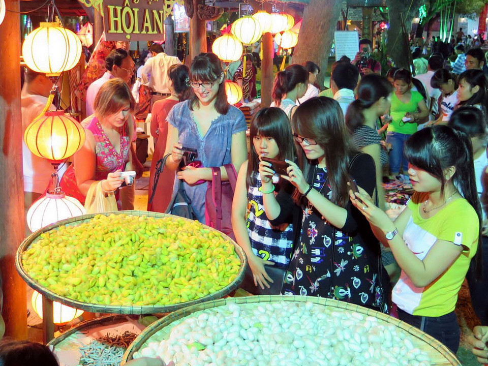 Gian trưng bày giới thiệu nghề truyền thống dệt lụa Hội An tại phố đêm trong Festival. (Ảnh: Quốc Việt/TTXVN)