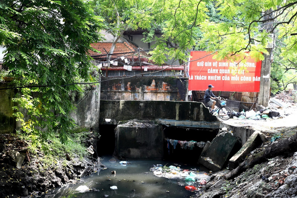 Một đoạn kênh qua địa bàn phường Kim Mã, quận Ba Đình bị rác thải vùi lấp, thu hẹp đáng kể dòng chảy. (Ảnh: Huy Hùng/TTXVN)