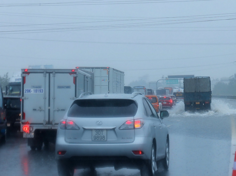 Các phương tiện di chuyển chậm qua đoạn ngập Km 191+500 trên cao tốc Pháp Vân-Cầu Giẽ (ảnh chụp lúc 10h30 ngày 11/9). (Ảnh: Hoàng Hiếu/TTXVN)