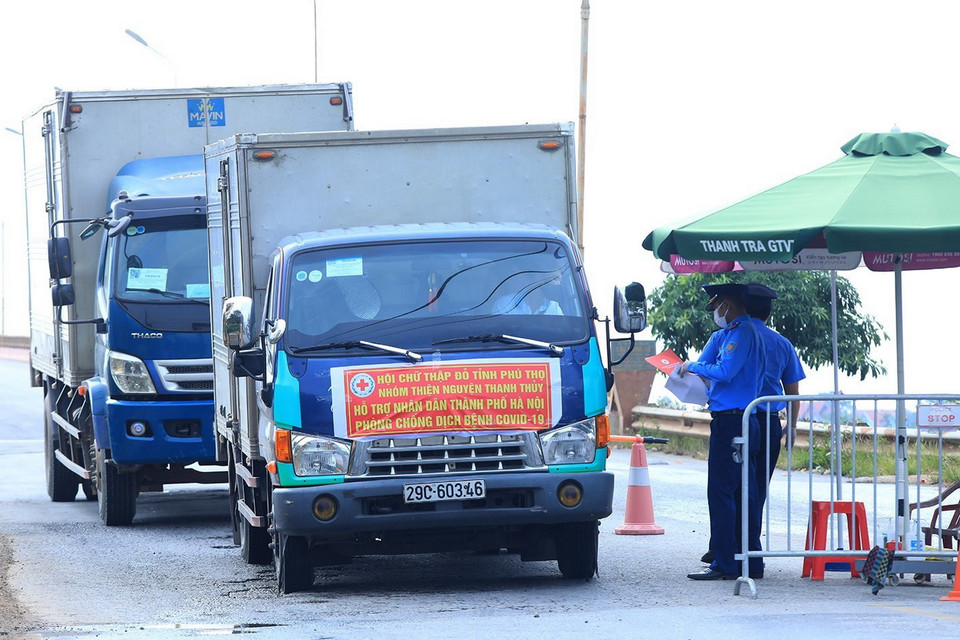  Lực lượng Thanh tra giao thông huyện Ba Vì kiểm tra giấy phép các phương tiện vận tải tại chốt kiểm dịch đầu cầu Trung Hà, huyện Ba vì. (Ảnh: Tuấn Anh/TTXVN)