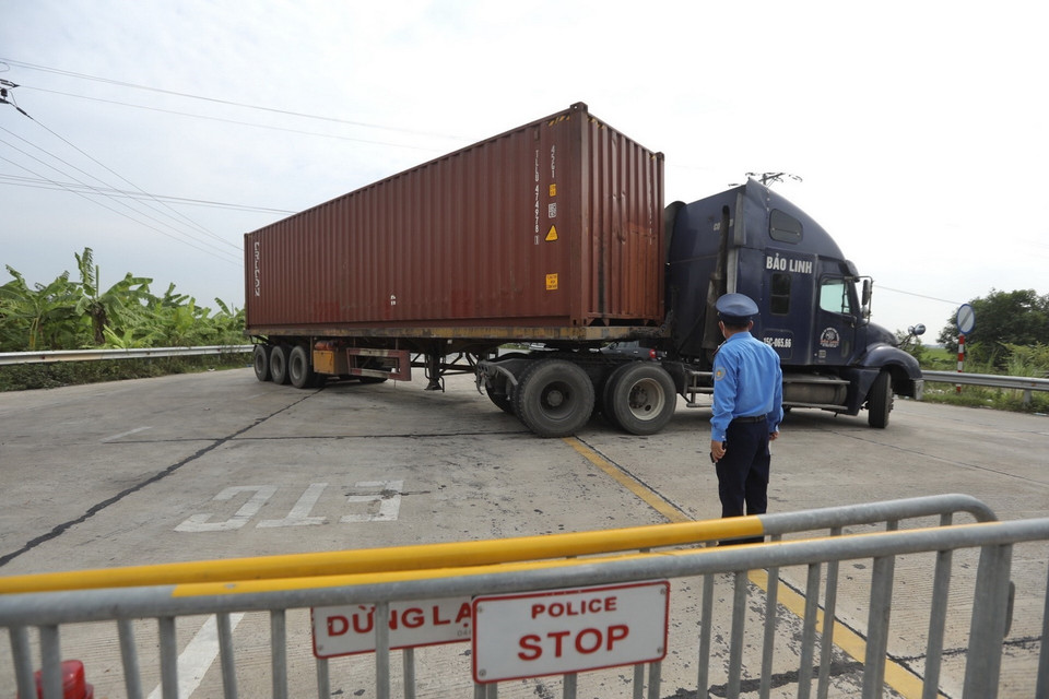  Chốt kiểm soát cầu Văn Lang (huyện Ba Vì), do không có luồng xanh nên các phương tiện xe tải, xe chở hàng thiết yếu bắt buộc phải quay đầu. (Ảnh: Minh Quyết/TTXVN)