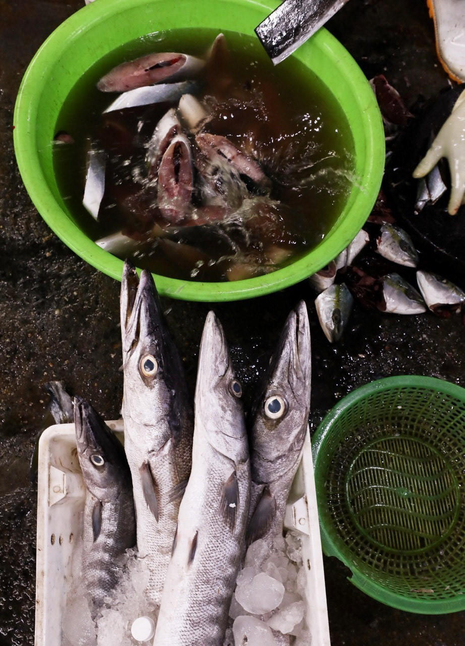 Cá và hải sản được sơ chế ngay tại chợ. (Ảnh: Lâm Khánh/TTXVN)