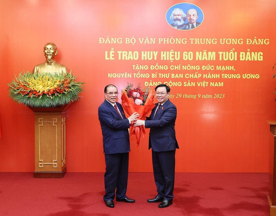 Đồng chí Vương Đình Huệ, Ủy viên Bộ Chính trị, Chủ tịch Quốc hội, chúc mừng nguyên Tổng Bí thư Nông Đức Mạnh. (Ảnh: Trí Dũng/TTXVN)