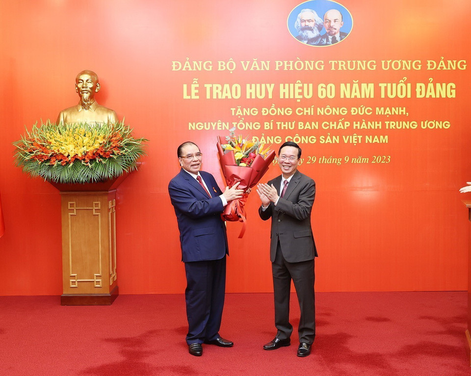 Đồng chí Võ Văn Thưởng, Ủy viên Bộ Chính trị, Chủ tịch nước, chúc mừng nguyên Tổng Bí thư Nông Đức Mạnh. (Ảnh: Trí Dũng/TTXVN)