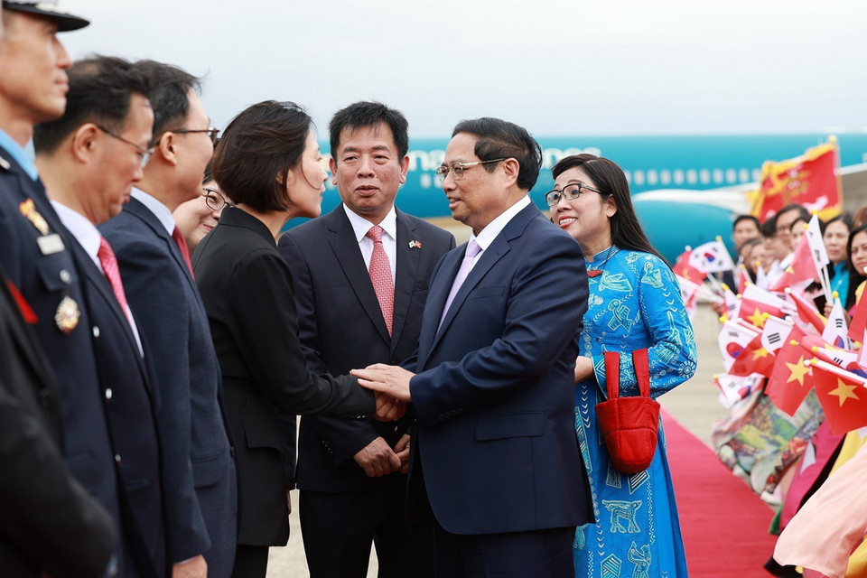Quan chức Hàn Quốc đón Thủ tướng Phạm Minh Chính và Phu nhân tại Sân bay quân sự Seongnam, tỉnh Gyeonggi. (Ảnh: Dương Giang/TTXVN)