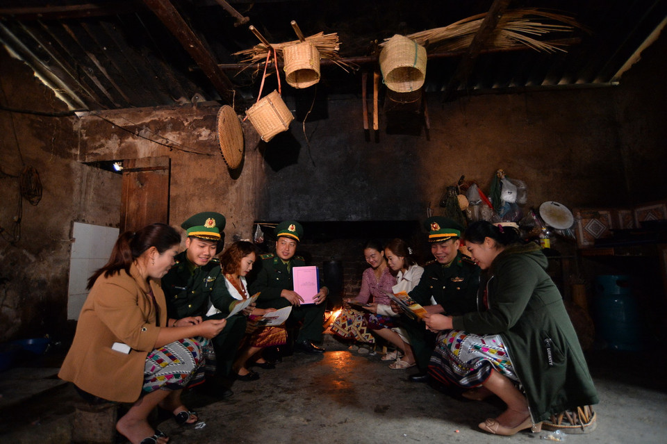 Cán bộ Đồn Biên phòng Pa Thơm tuyên truyền các chủ trương của Đảng, chính sách của Nhà nước cho bà con người dân tộc Lào tại bản Pa Xa Lào, xã biên giới Pa Thơm, huyện Điện Biên. (Ảnh: Minh Đức/TTXVN)