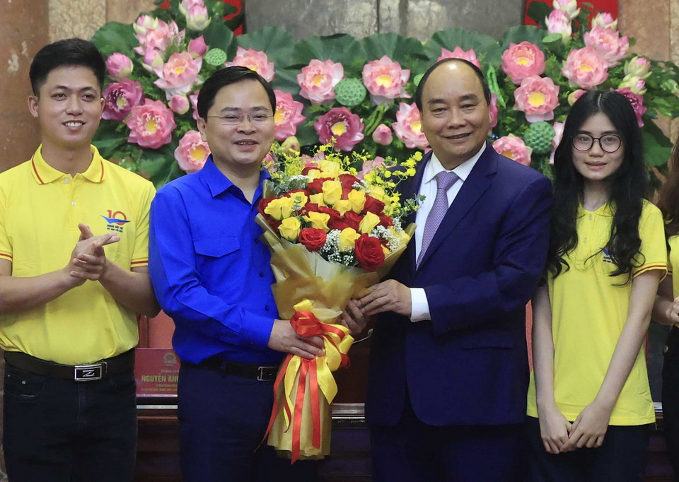 Chủ tịch nước Nguyễn Xuân Phúc tặng hoa chúc mừng đoàn viên, thanh niên nhân kỷ niệm 91 năm Ngày thành lập Đoàn. (Ảnh: Thống Nhất/ TTXVN)