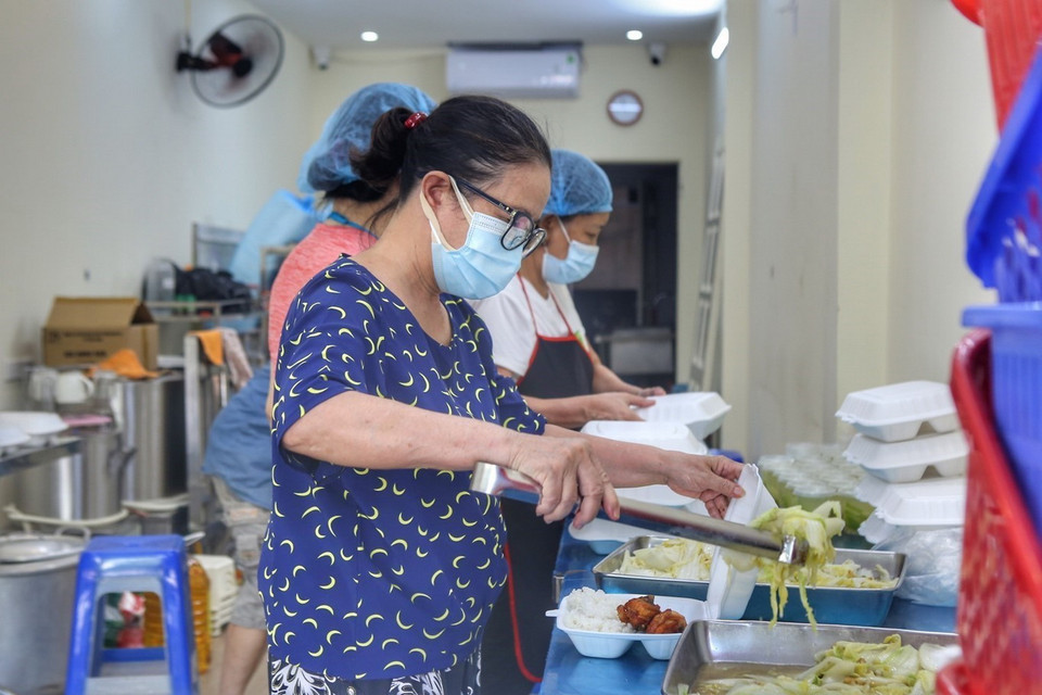Chuẩn bị các suất cơm miễn phí cho những hoàn cảnh khó khăn. (Ảnh: Tuấn Đức/TTXVN)
