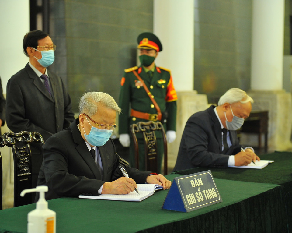 Nguyên Chủ tịch nước Trần Đức Lương và Phó Chủ tịch Quốc hội Uông Chu Lưu ghi sổ tang. (Ảnh: Minh Đức/TTXVN)