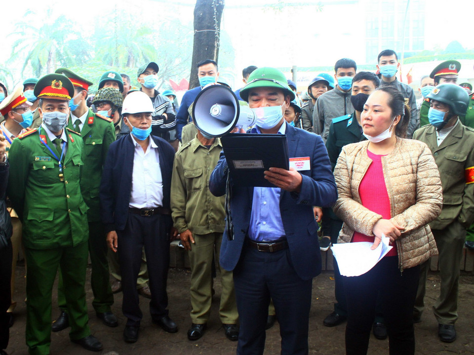 Đọc lệnh cưỡng chế phá dỡ các nhà chung cư B3 và B6, Khu B chung cư Quang Trung. (Ảnh: Tá Chuyên/TTXVN)