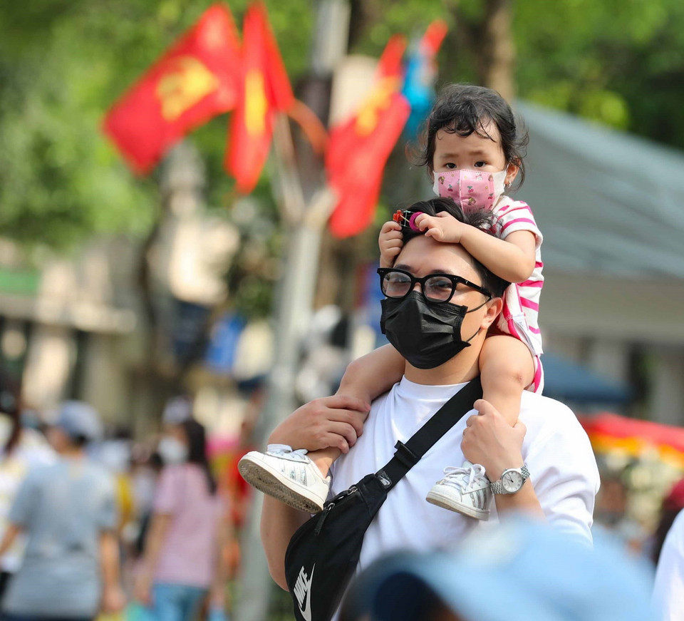 Em nhỏ được đi chơi phố đi bộ. (Ảnh: Thanh Tùng/TTXVN) 