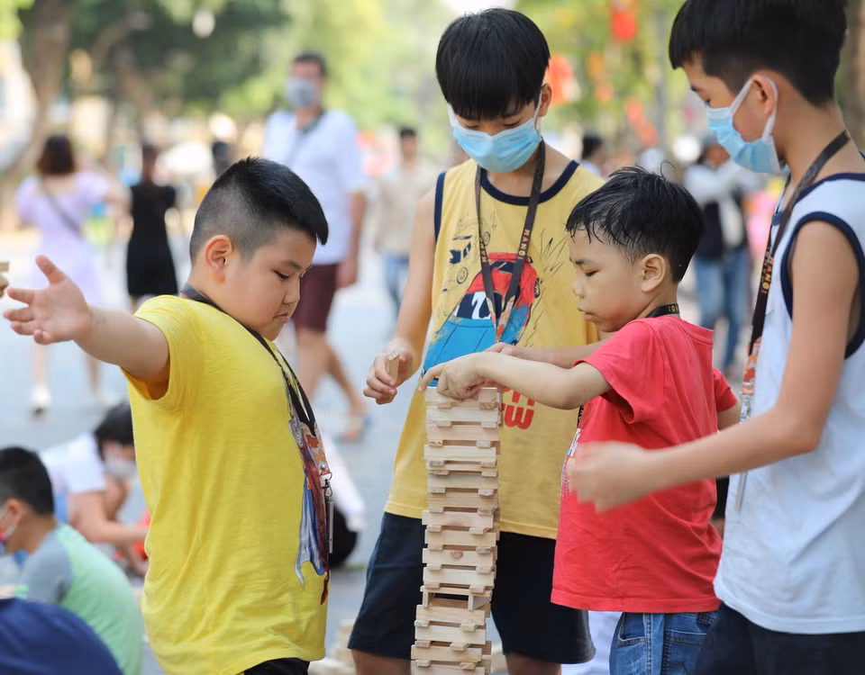 Các em nhỏ háo hức với trò chơi cùng gỗ. (Ảnh: Thanh Tùng/TTXVN)