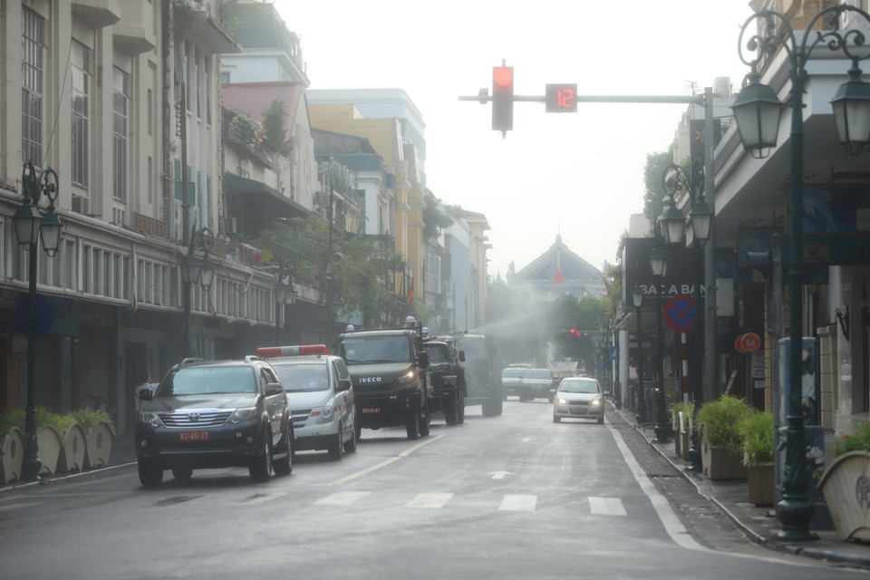 Hình ảnh lực lượng chức năng khử khuẩn tại phố Tràng Tiền (Ảnh: Hoàng Đạt/Vietnam+)