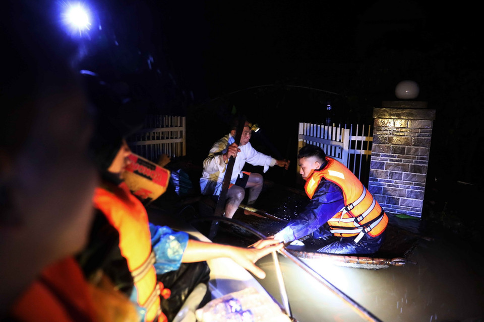  Lực lượng quân đội tỉnh Hà Tĩnh bơi thuyền vào cứu trợ ông Phan Thanh Đức bị cô lập tại thôn Ngũ Phúc, xã Cẩm Vĩnh, huyện Cẩm Xuyên. Ảnh chụp đêm 20/10 vừa qua. (Ảnh: TTXVN)