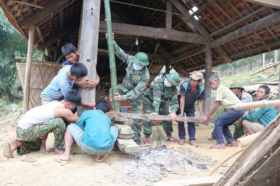  Bộ đội biên phòng đồn Môn Sơn, huyện Con Cuông, tỉnh Nghệ An, giúp đồng bào dân tộc dựng nhà. (Ảnh: Nguyễn Oanh/TTXVN)