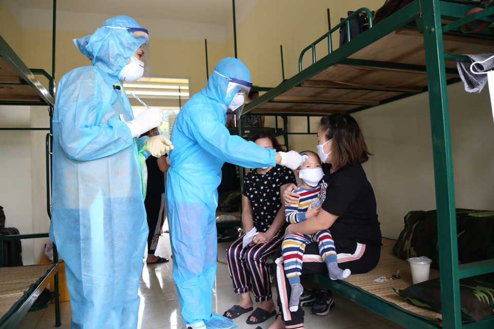 Kiểm tra sức khỏe hằng ngày cho người dân tại khu vực cách ly. (Ảnh: Dương Giang/TTXVN)