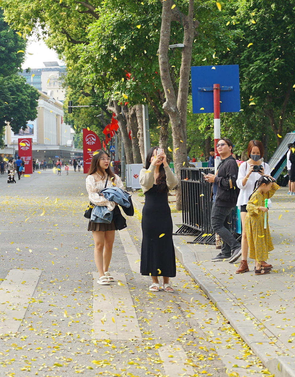 Các bạn trẻ lưu lại khoảng khắc mùa Thu Hà Nội tại phố đi bộ hồ Hoàn Kiếm. (Ảnh: Khánh Hòa/TTXVN)