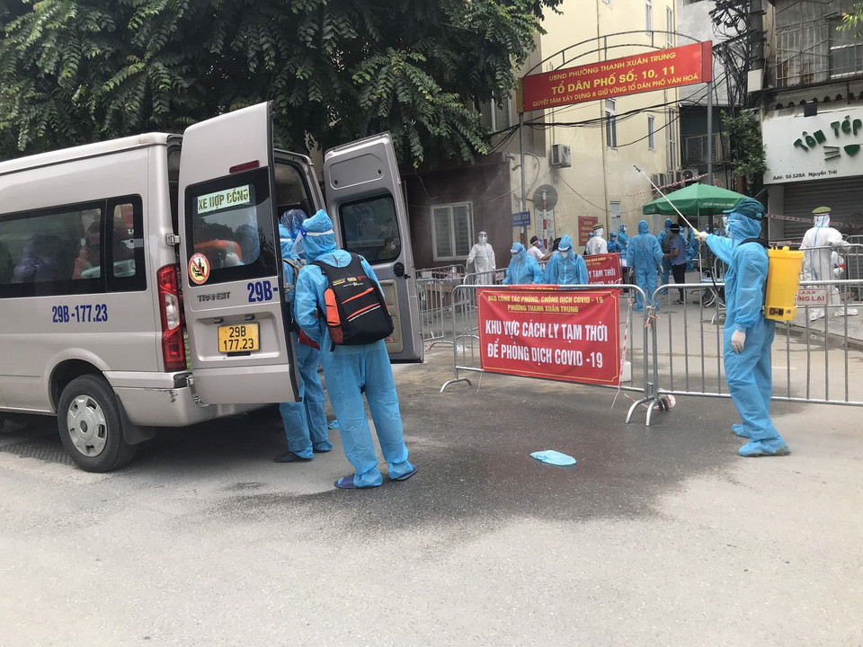 Vận chuyển các trường hợp F1 đi cách ly. (Ảnh: Văn Cảnh/TTXVN)