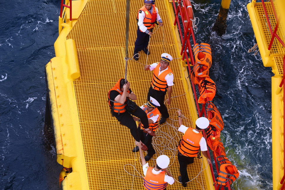 Các chiến sỹ đảm bảo an toàn cho các đại biểu khi lên nhà giàn. (Ảnh: Văn Điệp/TTXVN)