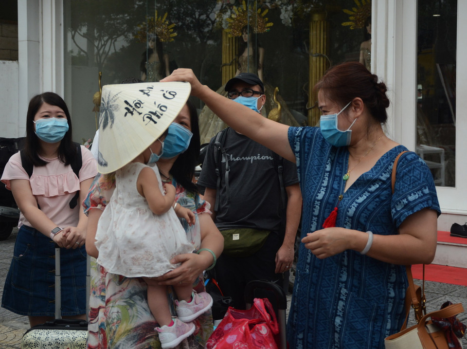 Du khách hoàn thành cách ly chào tạm biệt, lên xe ra sân bay trở về nước. (Ảnh: Văn Dũng/TTXVN)