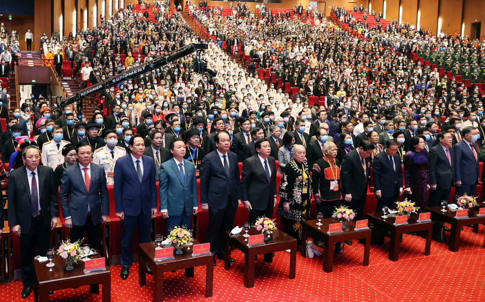 Các vị lãnh đạo, nguyên lãnh đạo Đảng, Nhà nước và đại biểu thực hiện nghi lễ chào cờ. (Ảnh: Thống Nhất/TTXVN)