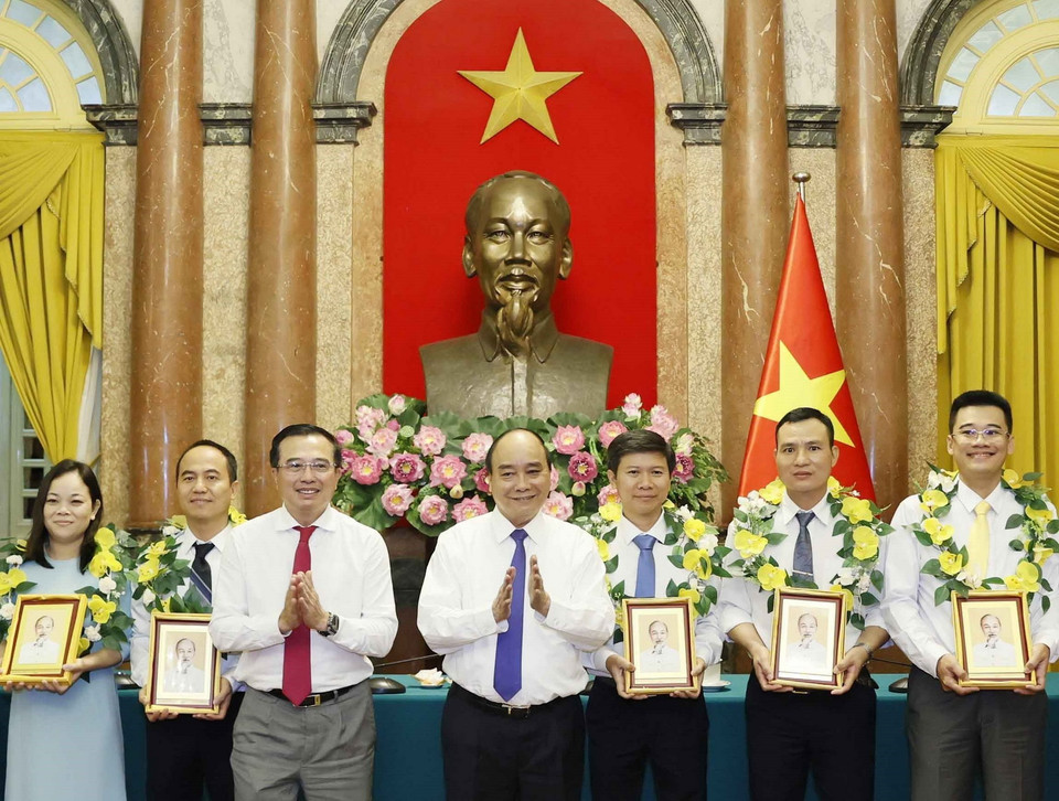 Chủ tịch nước tặng chân dung Chủ tịch Hồ Chí Minh cho cán bộ, công nhân lao động tiêu biểu ngành Dầu khí. (Ảnh: Thống Nhất/TTXVN)