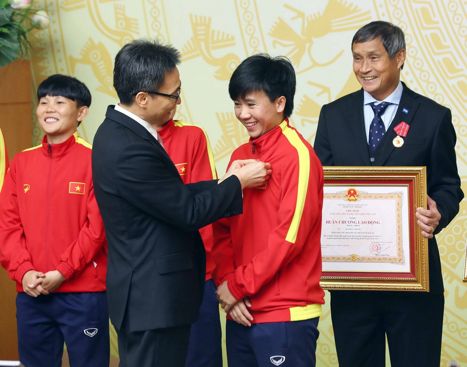  Phó Thủ tướng Vũ Đức Đam gắn Huân chương Lao động hạng Nhì, hạng Ba cho các cầu thủ Đội tuyển Bóng đá Nữ Việt Nam có thành tích xuất sắc. (Ảnh: Phạm Kiên/TTXVN)