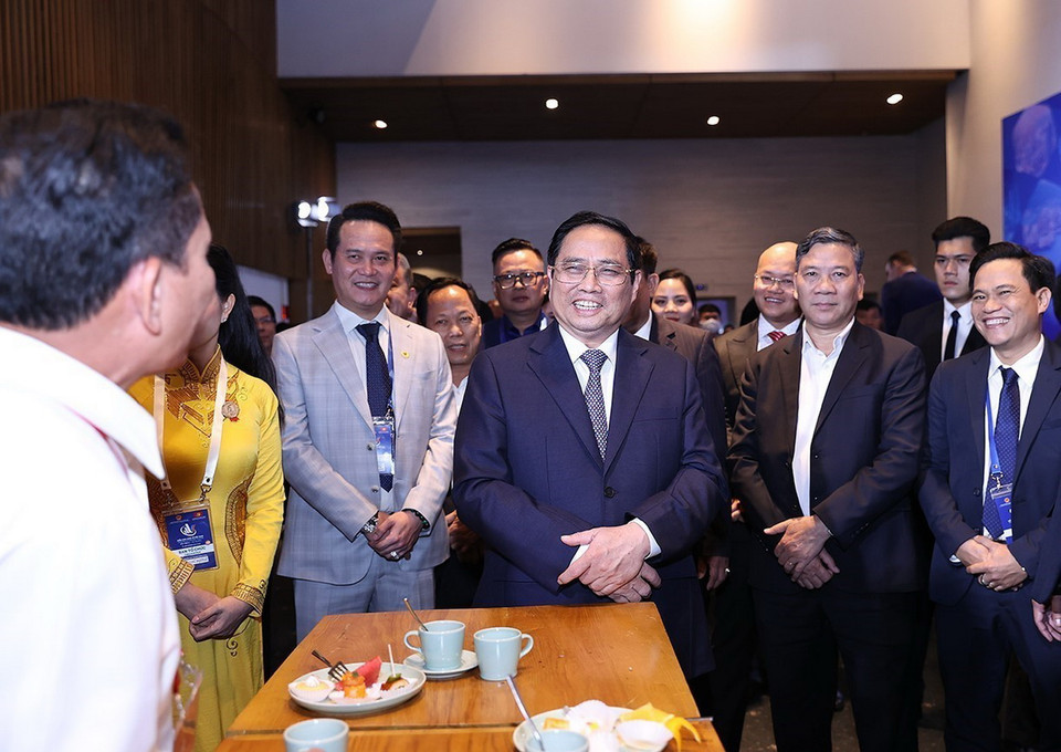 Thủ tướng Phạm Minh Chính vui vẻ trao đổi với các đại biểu dự Diễn đàn Kinh tế Việt Nam lần thứ tư. (Ảnh: Dương Giang/TTXVN)