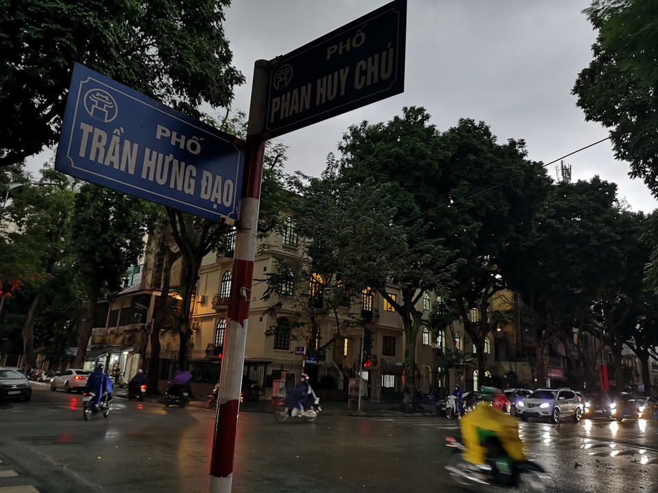 Bầu trời Hà Nội tối sầm, kèm mưa lớn khiến các phương tiện giao thông phải bật đèn khi di chuyển. (Ảnh: Thanh Tùng/TTXVN)