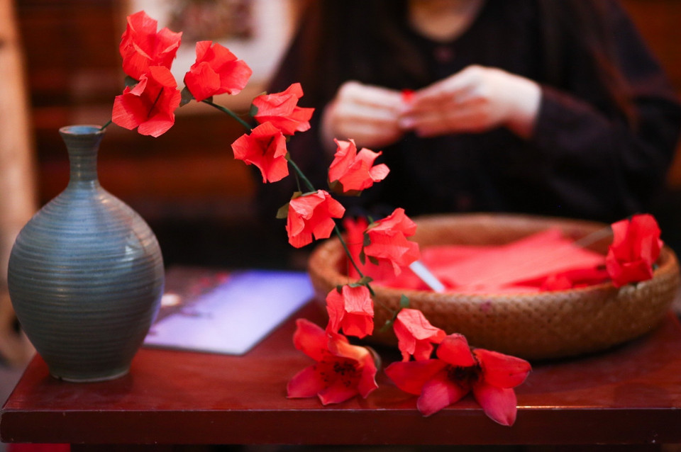 Nghệ nhân gấp hoa gạo bằng giấy. (Ảnh: Thu Phương/TTXVN phát)