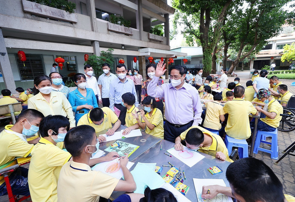 Sáng 24/1, Thủ tướng Phạm Minh Chính với trẻ em đang được chăm sóc tại Trung tâm bảo trợ trẻ tàn tật mồ côi Thị Nghè. (Ảnh: Dương Giang/TTXVN)