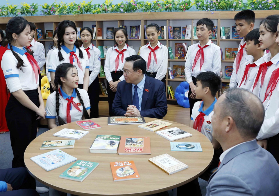 Chủ tịch Quốc hội Vương Đình Huệ trò chuyện với học sinh Trường THCS Nam Thanh. (Ảnh: Nhan Sáng/TTXVN)