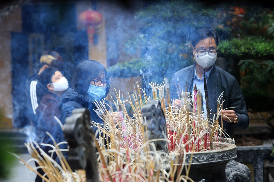 Các gia đình đi lễ chùa để cầu một năm mới bình an và gặp nhiều may mắn. (Ảnh: Tuấn Anh/TTXVN)