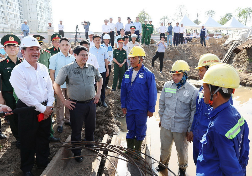 Thủ tướng Phạm Minh Chính động viên công nhân, người lao động đang thi công đường Vành đai 3 đoạn qua Thành phố Hồ Chí Minh. (Ảnh: Dương Giang/TTXVN)