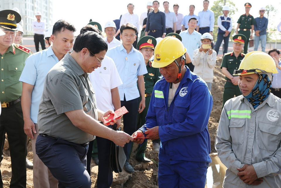 Thủ tướng Phạm Minh Chính chúc Tết công nhân, người lao động đang thi công đường Vành đai 3 đoạn qua Thành phố Hồ Chí Minh. (Ảnh: Dương Giang/TTXVN)