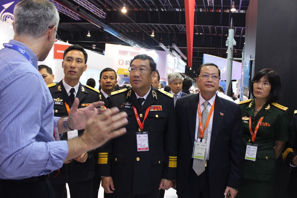 Chuẩn Đô đốc Phạm Hoài Nam (đứng thứ 3 từ trái sang) và Đại sứ Việt Nam tại Singapore Nguyễn Tiến Minh (thứ 4 từ trái sáng) cùng đoàn Việt Nam thăm quan một gian hàng triển lãm.