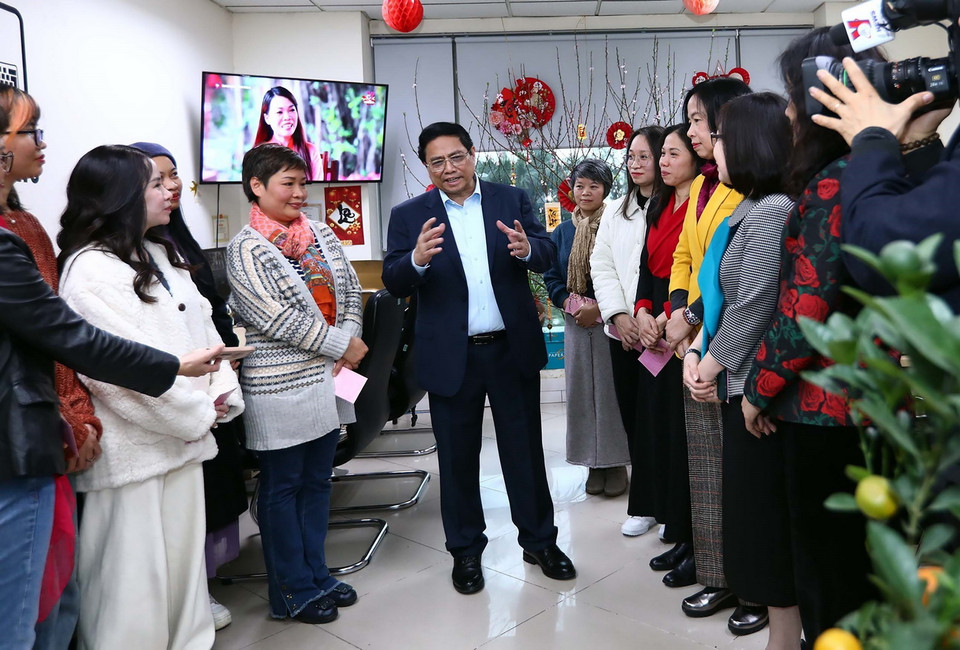 Thủ tướng Phạm Minh Chính động viên chúc mừng năm mới phóng viên, biên tập viên Ban Biên tập Tin Thế giới. (Ảnh: Huy Hùng/TTXVN)