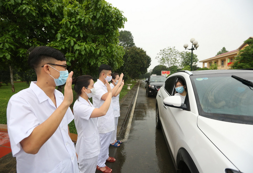 Các cán bộ, chiến sỹ quân y Trung đoàn 58 chào tạm biệt các công dân đã hoàn thành thời gian cách ly trở về địa phương. (Ảnh: Dương Giang/TTXVN)