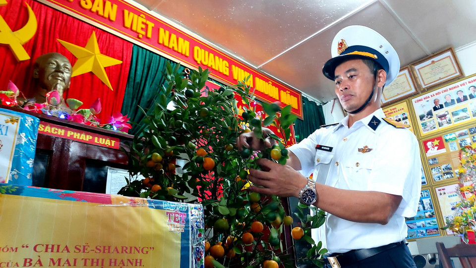 Thiếu tá Đào Văn Huyên, Nhân viên cơ yếu nhà giàn DK1/10 (bãi cạn Cà Mau) trang trí chậu quất Tết. (Ảnh: Thu Hiền/TTXVN)