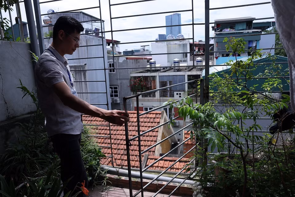 Kiểm tra cửa thoát hiểm trên tầng tum của một khu nhà trọ trên đường Nguyễn Khánh Toàn, phường Quan Hoa. (Ảnh: Tuấn Anh/TTXVN)