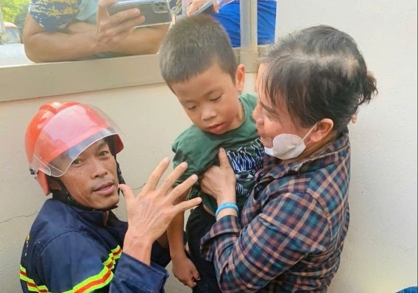 Cháu bé bị mắc kẹt chân trong ống nước. (Ảnh: TTXVN phát)