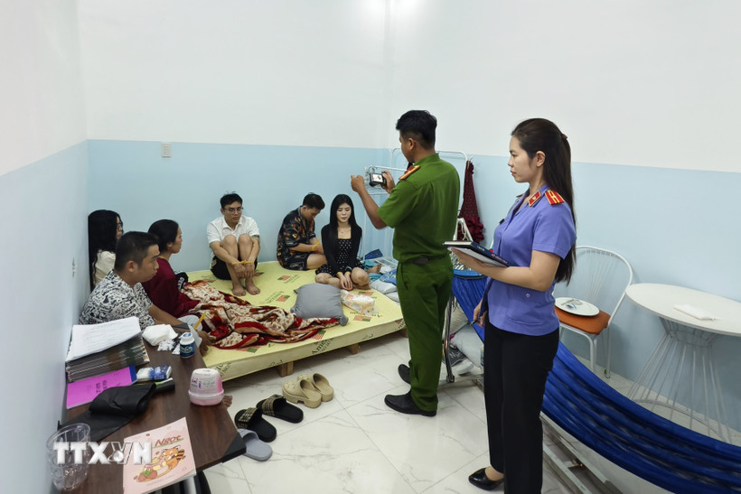 Nhóm đối tượng bị bắt quả tang sử dụng ma túy tại tầng trệt. (Ảnh: TTXVN phát)