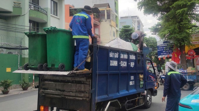Công nhân ngành môi trường thu gom rác sinh hoạt tại phường Tân Bình, TPHCM. (Ảnh SGGP)
