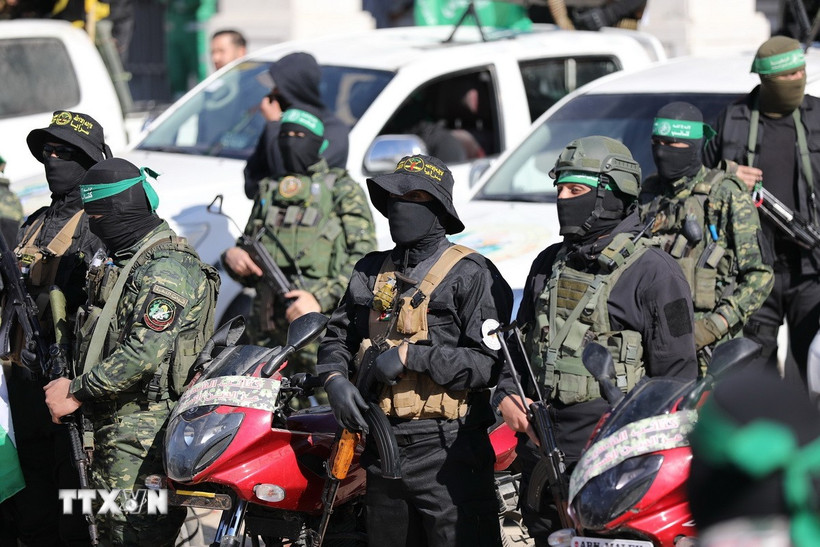 Các thành viên Lữ đoàn Al-Qassam và Al-Quds được triển khai trong lễ trao trả bốn nữ binh sỹ Israel cho Ủy ban Chữ thập Đỏ Quốc tế (ICRC) tại thành phố Gaza, ngày 25/1/2025. (Ảnh: AA/TTXVN)